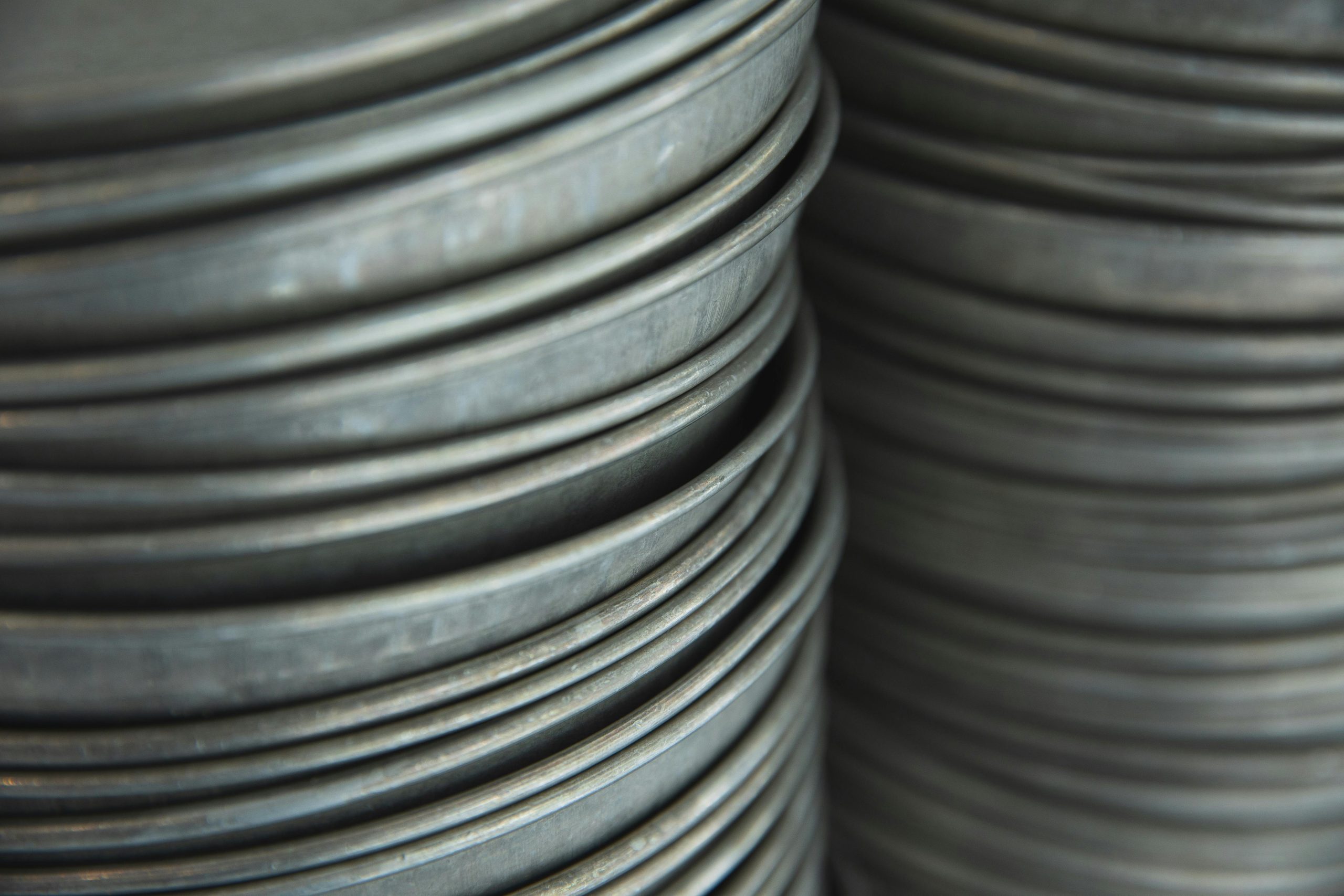 Close-up of stacked metallic plates showing texture and light play.